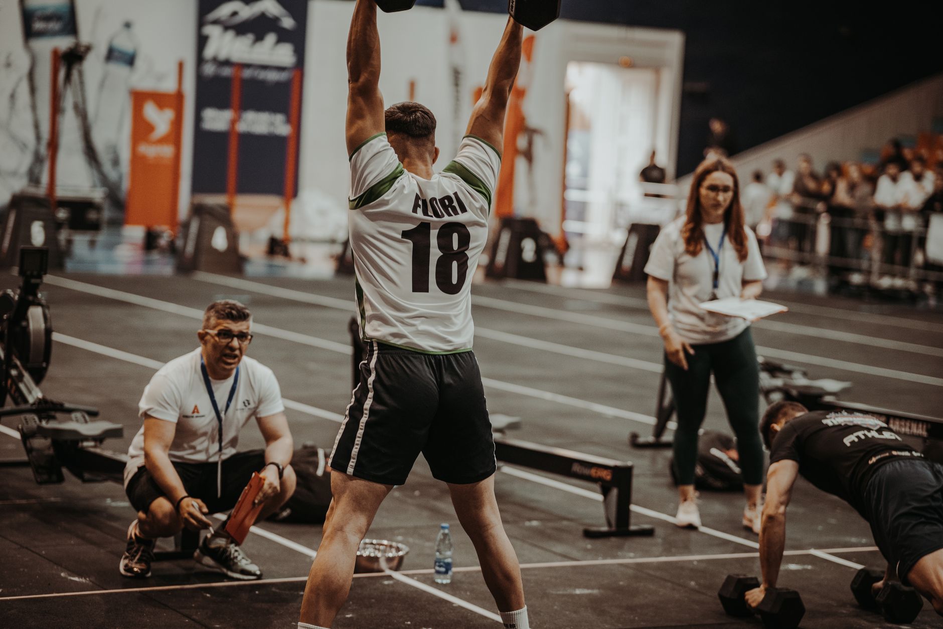 Athletes competing fiercely in an indoor gym, showcasing strength and determination.